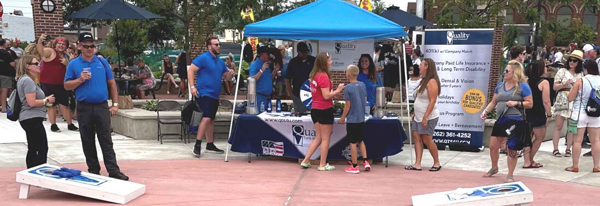 outdoor popup tent with swag table at an event